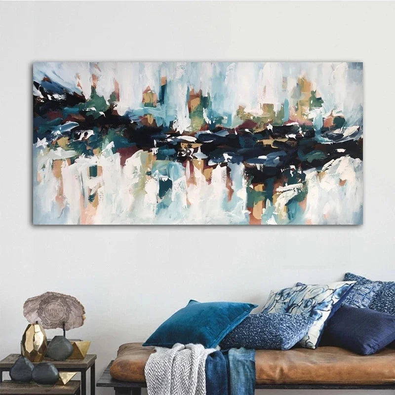 A blue shades abstract canvas print mounted on a white wall in a lounging area.