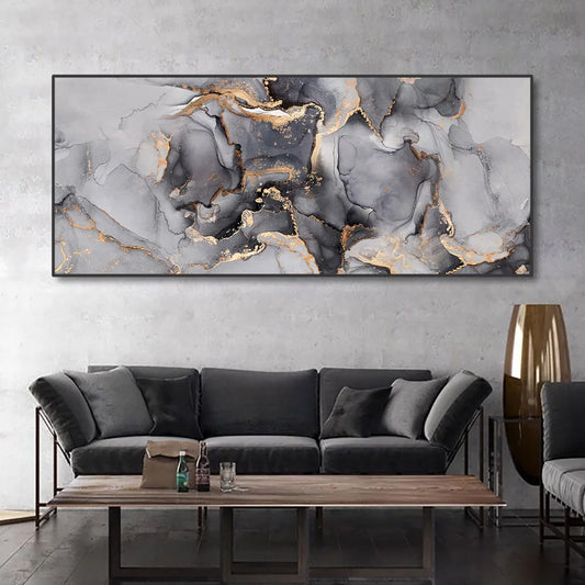 A modern wall art canvas, in shades of grey with gold detail, set in a living room