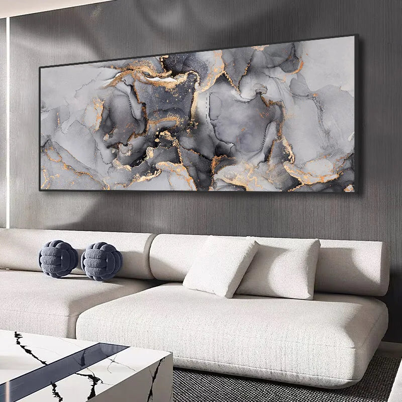 A modern wall art canvas, in shades of grey with gold detail, framed on a wall