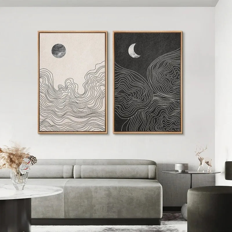 2 minimalist canvases mounted on a living room wall - 1 depicts the sun, 1 depicts the moon